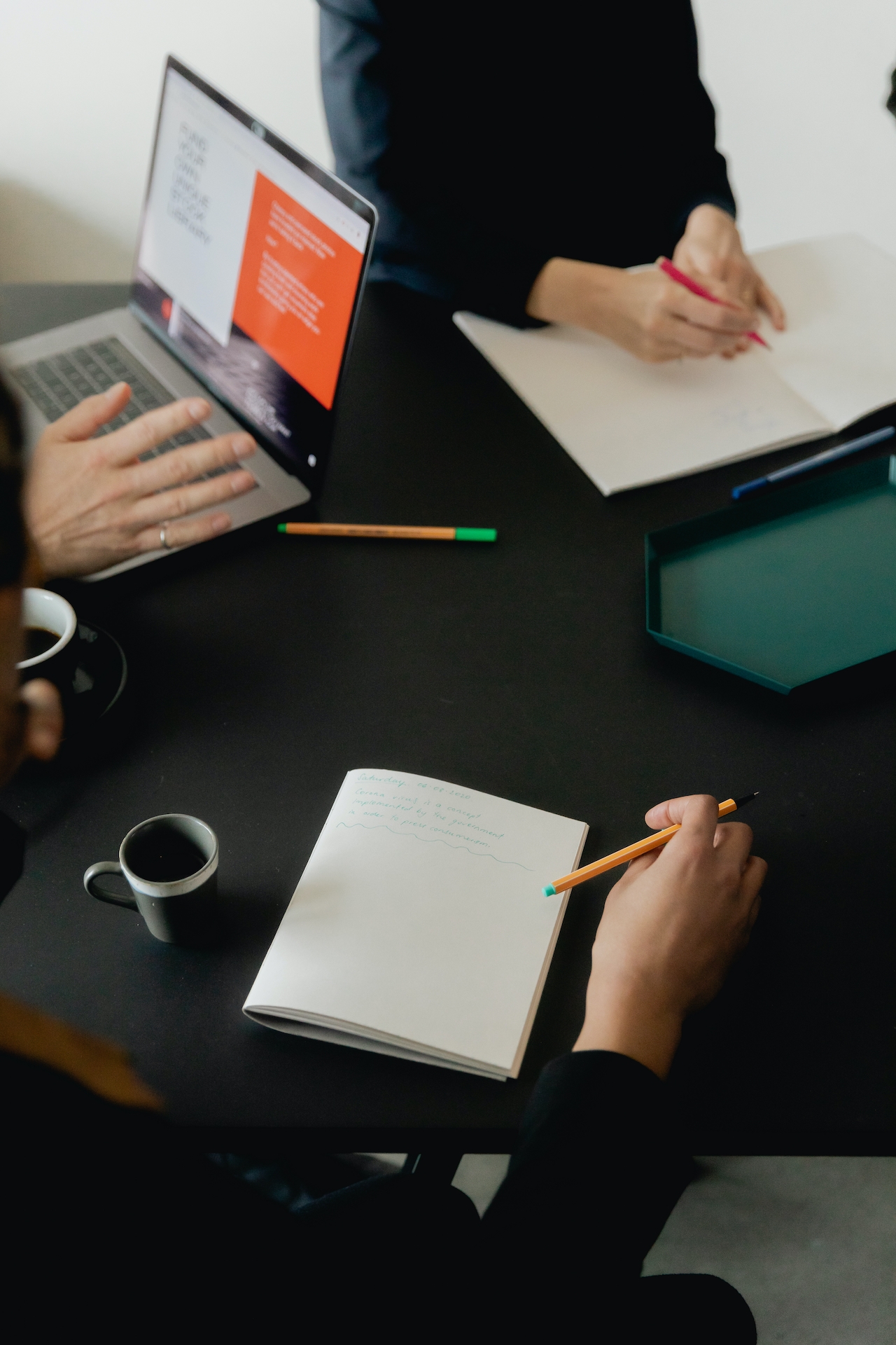 3 people attend a meeting. Used as the promotional image for a blog about whether or not copywriting is worth the money in 2024.